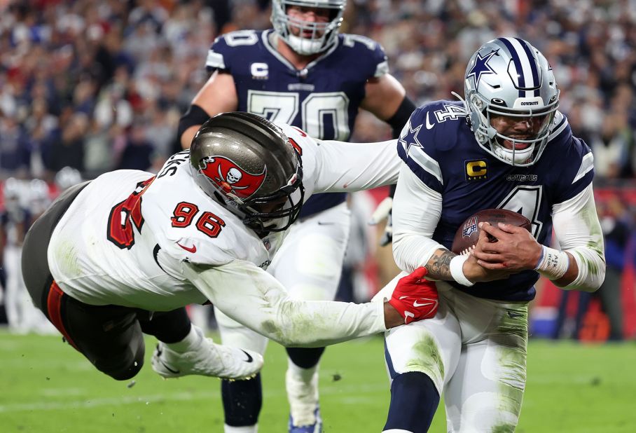 Dallas Cowboys quarterback Dak Prescott rushes the ball for a touchdown against Tampa Bay Buccaneers defensive end Akiem Hicks in the first half. Prescott accounted for five touchdowns -- one rushing and four passing -- in the Cowboys' 31-14 victory over the Bucs to set up a clash against the San Francisco 49ers in the next round of the playoffs.