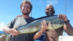 Isaac Danian and Shukree Abdul-Rashed after catching a fish on the boat "Zulu Time".