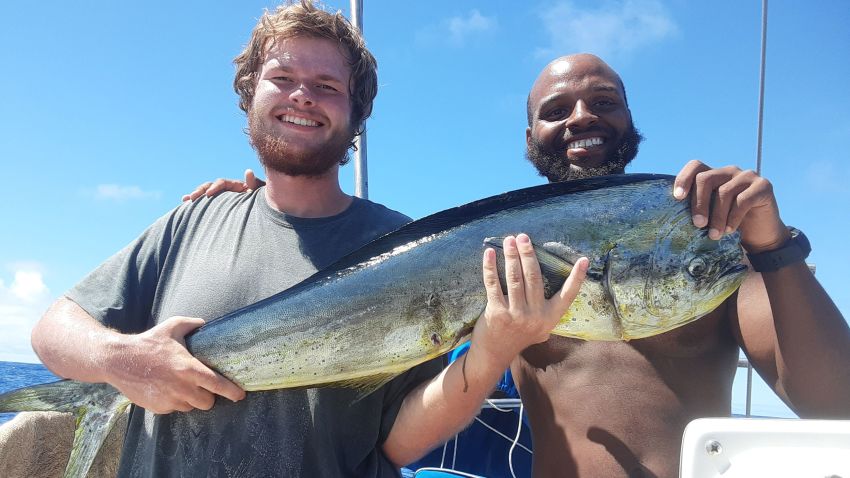 Isaac Danian and Shukree Abdul-Rashed after catching a fish on the boat "Zulu Time".