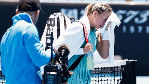 Anett Kontaveit of Estonia walks off court as play is suspended due to extreme heat in her match against Julia Grabher of Austria during day two of the 2023 Australian Open.
