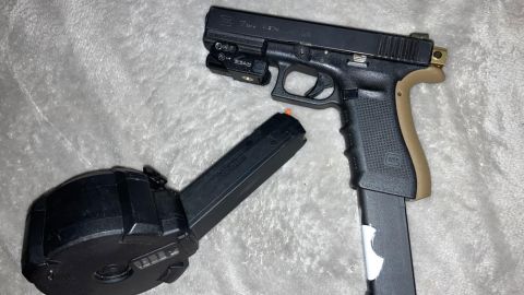 Albuquerque police released a photo of a "tan and black Glock with a drum magazine" that the affidavit said matches one of the guns seized from the suspect during a traffic stop.