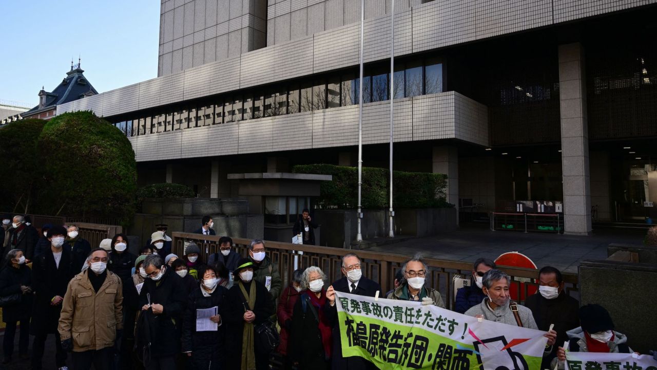 People take part in a rally calling for three former TEPCO executives to be found guilty of professional negligence in the appeal trial over the Fukushima nuclear disaster, in front of the main gate of the Tokyo High Court on January 18, 2023. 