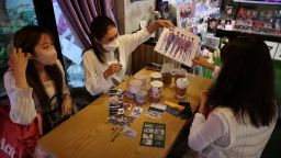 Japanese fans of K-pop boy band BTS, Hori, Tanaka Rina and Ohkubo share a moment at a cafe featuring BTS goods in Seoul, South Korea, June 15, 2022.  REUTERS/Kim Hong-Ji