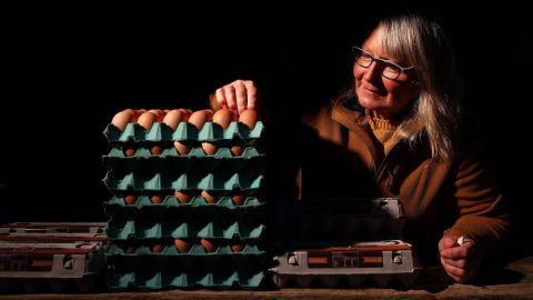 An egg vendor setting up her stall before dawn at a farmers market in 2020 in Auckland. New Zealand is currently undergoing a major egg shortage, squeezing businesses and sparking a rush in demand for pet chickens.