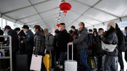 People walk with their luggage at a railway station during the annual Spring Festival travel rush ahead of the Chinese Lunar New Year, as the Covid-19 outbreak continues, in Shanghai, China January 16, 2023. 