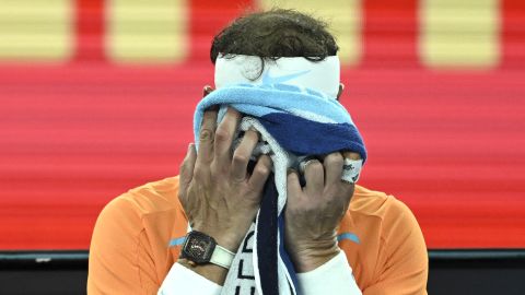 Nadal puts his head in his hands during his Australian Open defeat. 