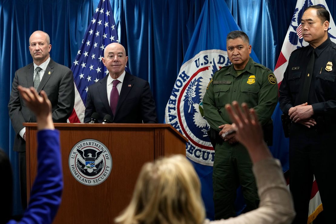 Homeland Security Secretary Alejandro Mayorkas, second from left, looks to responder to a reporter's question during a news conference. 