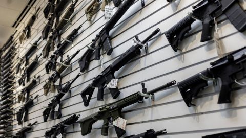 A selection of AR-15-style rifles hangs on a wall at R-Guns store on January 11, 2023, in Carpentersville, Illinois, a day after the state ban was signed into law.
