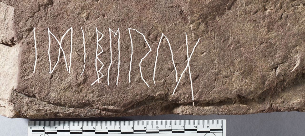 Eight runes on the front face of the stone spell "idiberug" -- possibly a woman's name.