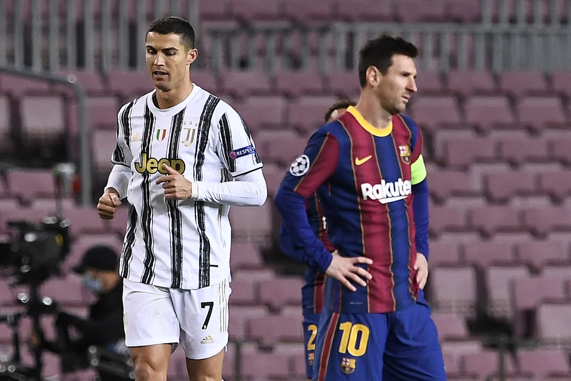 Cristiano Ronaldo (L) walks past Argentinian Lionel Messi during a UEFA Champions League football match in Barcelona on December 8, 2020. 