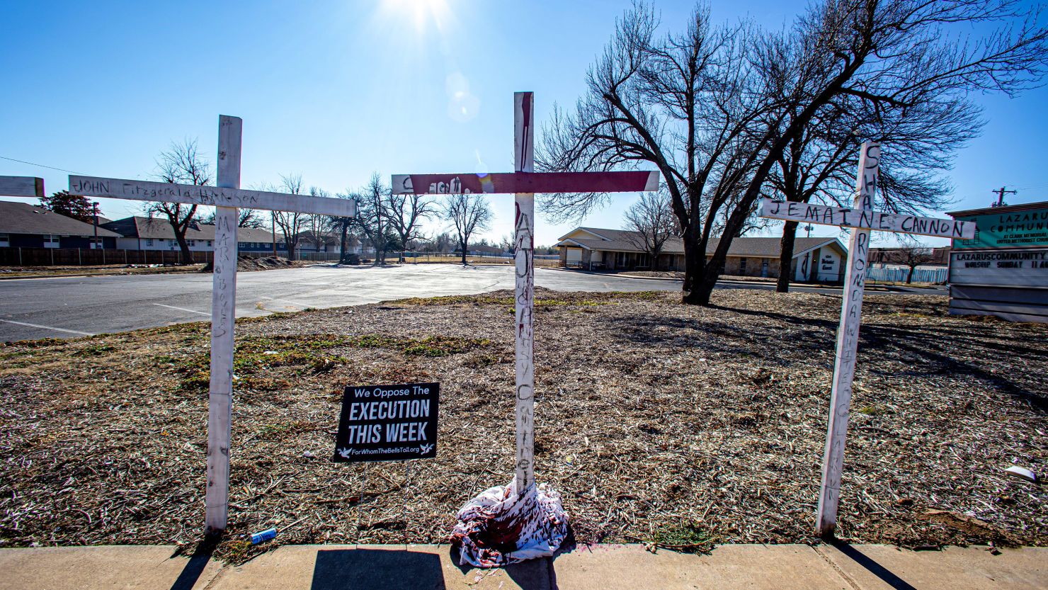 A cross was painted red on January 13, 2023, on the lawn of The Lazarus Community at Clark Memorial United Methodist Church to represent Scott Eizember, who was executed the day before.