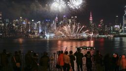 WEEHAWKEN, NJ - FEBRUARY 14: People watch fireworks explode over the Hudson River against the backdrop of Manhattan marking Chinese New Year celebrations on February 14, 2018 in Weehawken, New Jersey. In China celebrations begin Friday, starting one of the world's great migrations. Also known as Spring Festival or Lunar New Year, at least 385 million Chinese people are expected to leave the major cities to visit their families in rural parts of the country to mark the Year of the Dog.