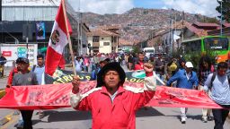 A man holds a Peruvian flag as he takes part in a demonstration before heading to Lima, to gather with protesters from around the country for the 'capture of Lima' march, calling for the resignation of Peru's President Dina Boluarte, following the ousting and arrest of former President Pedro Castillo, in Cusco, Peru, January 18, 2023. REUTERS/Paul Gambin NO RESALES. NO ARCHIVES