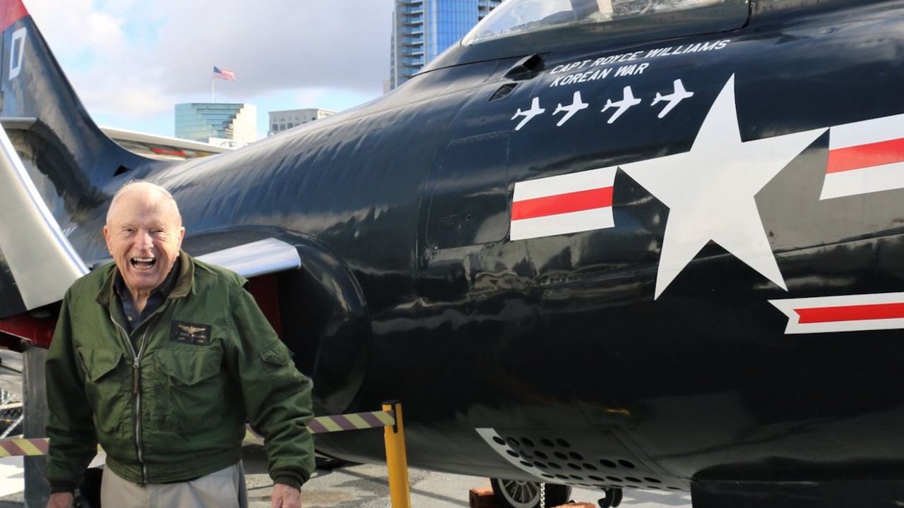 Royce Williams is pictured with a replica of the plane in which he shot down four Soviet MiG fighter jets in 1952.