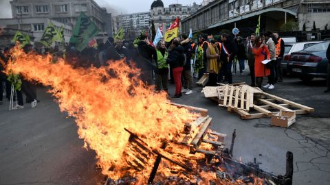 Wooden pallets burn, as demonstrators gather during a rally called by French trade unions outside the Gare de Lyon, in Paris on January 19, 2023.