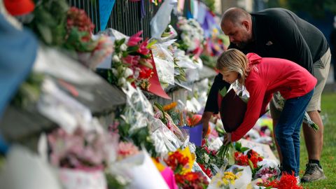 Mourners lay flowers on a wall at the Botanic Gardens in Christchurch, New Zealand, March 16, 2019.