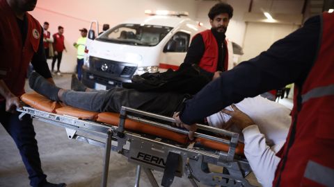 Health workers carry fans injured in a stampede with a stretcher in Basra, Iraq January 19.
