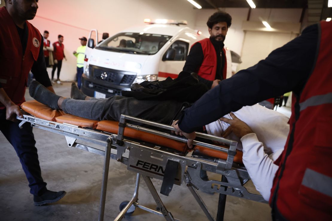 Health care workers carry fans injured in a stampede with a stretcher in Basra, Iraq on January 19.
