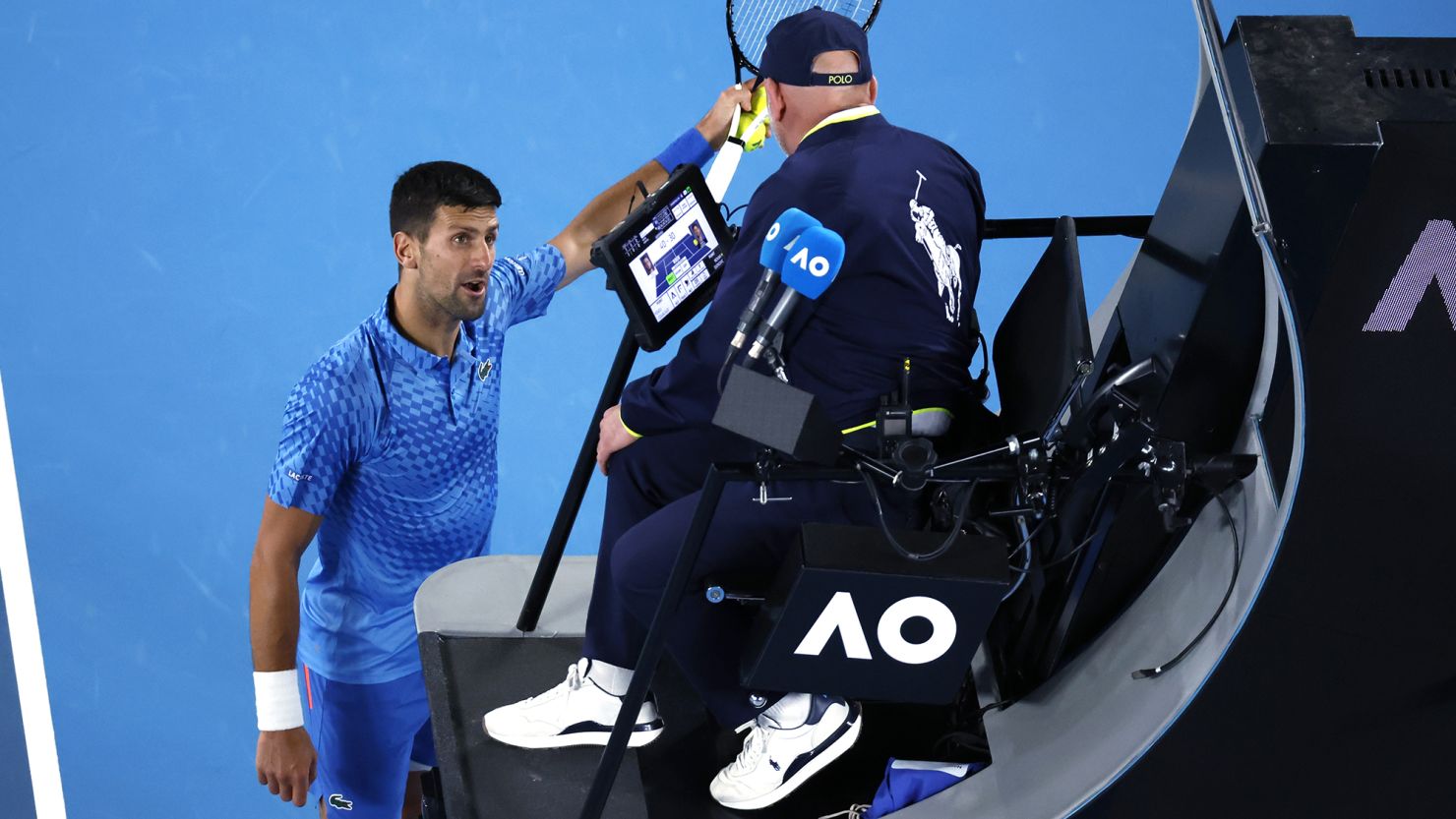 Novak Djokovic argues with the chair umpire during his second round match against Enzo Couacaud.