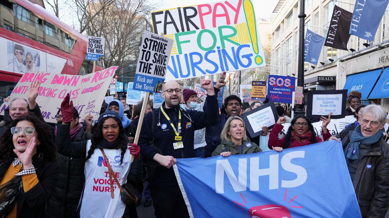 NHS nurses hold signs during a strike, amid a dispute with the government over pay, in London, Britain December 20, 2022. REUTERS/Maja Smiejkowska

