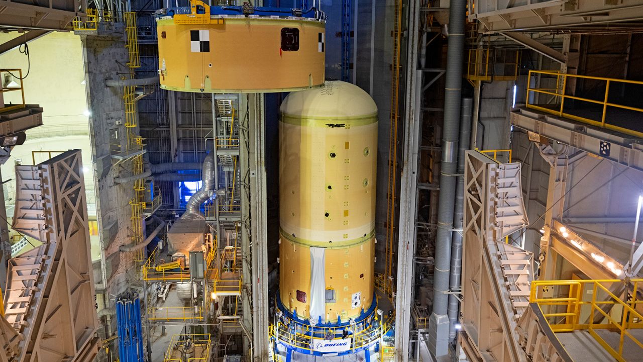 This image shows technicians and engineers at NASA's Michoud Assembly Facility moving and connecting the forward skirt to the liquid oxygen tank (LOX) as they continue the process of the forward join on the core stage of NASA's Space Launch System rocket for Artemis II, the first crewed mission of NASA's Artemis program. Image credit: NASA/Michael DeMocker