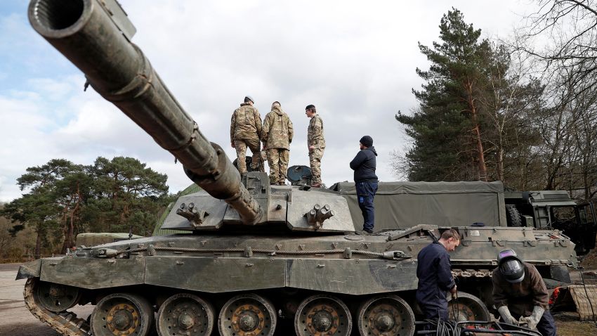 Soldiers work on a Challenger 2 main battle tank during during the Royal Electrical & Mechanical Engineers training exercise called "Iron Challenge" at the Longmoor training area, near Bordon, Hampshire, on March 14, 2022.