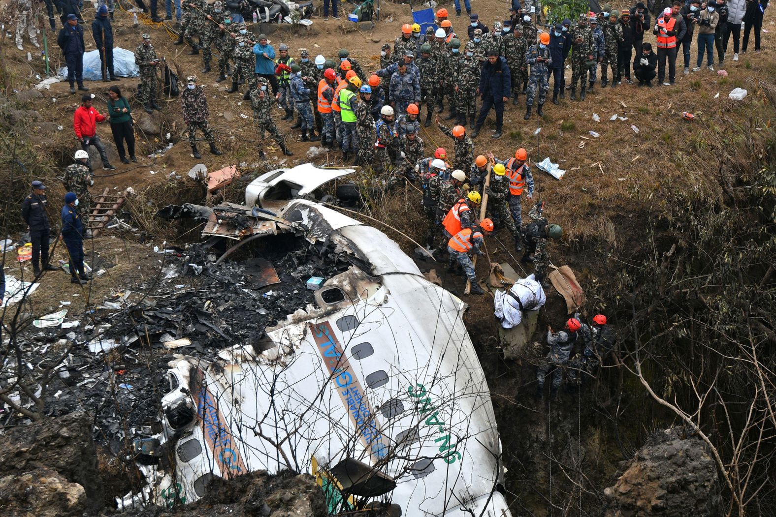 Rescuers pull the body of a victim who died in a <a href="https://www.cnn.com/2023/01/17/asia/nepal-plane-crash-yeti-airlines-video-intl-hnk/index.html" target="_blank">Yeti Airlines plane crash</a> in Pokhara, Nepal, on Monday, January 16. There were 72 people on board, including four crew members, according to an airline spokesperson. With all but one body recovered, the crash marks the country's <a href="https://www.cnn.com/2023/01/15/asia/nepal-air-travel-risks-intl/index.html" target="_blank">deadliest air disaster</a> in more than 30 years.