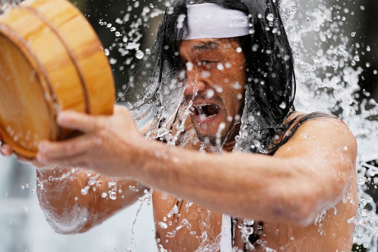 A half-naked shrine parishioner douses himself with cold water during a cold-endurance ritual at the Kanda Myojin Shinto shrine in Tokyo, Japan, on Saturday, January 14. Pouring cold water on their bodies is believed to be purifying their souls.