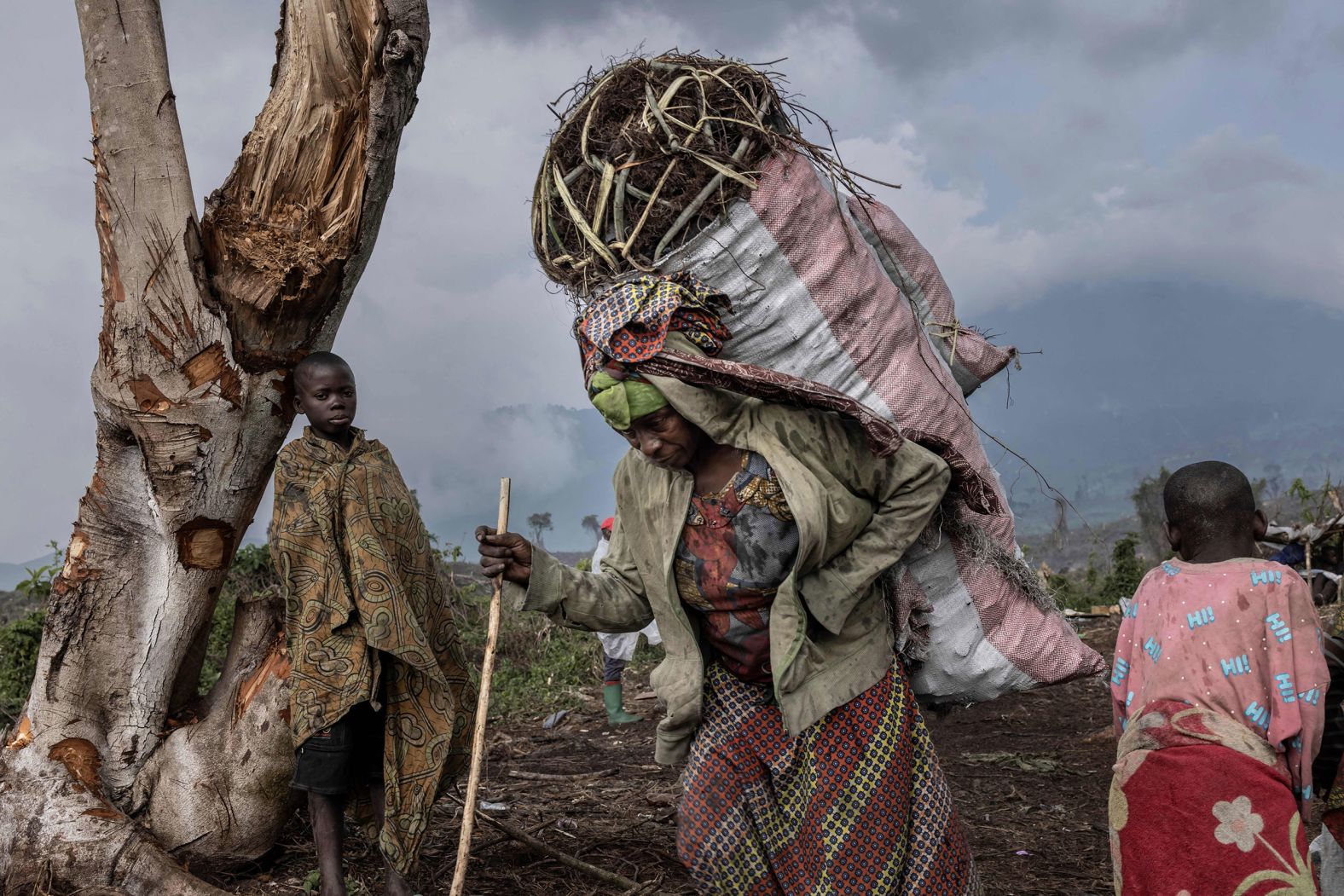 Internally displaced people carry charcoal harvested from a forest at the foot of Mount Nyiragongo in the Democratic Republic of Congo to sell at a market in Kibati on Friday, January 13.
