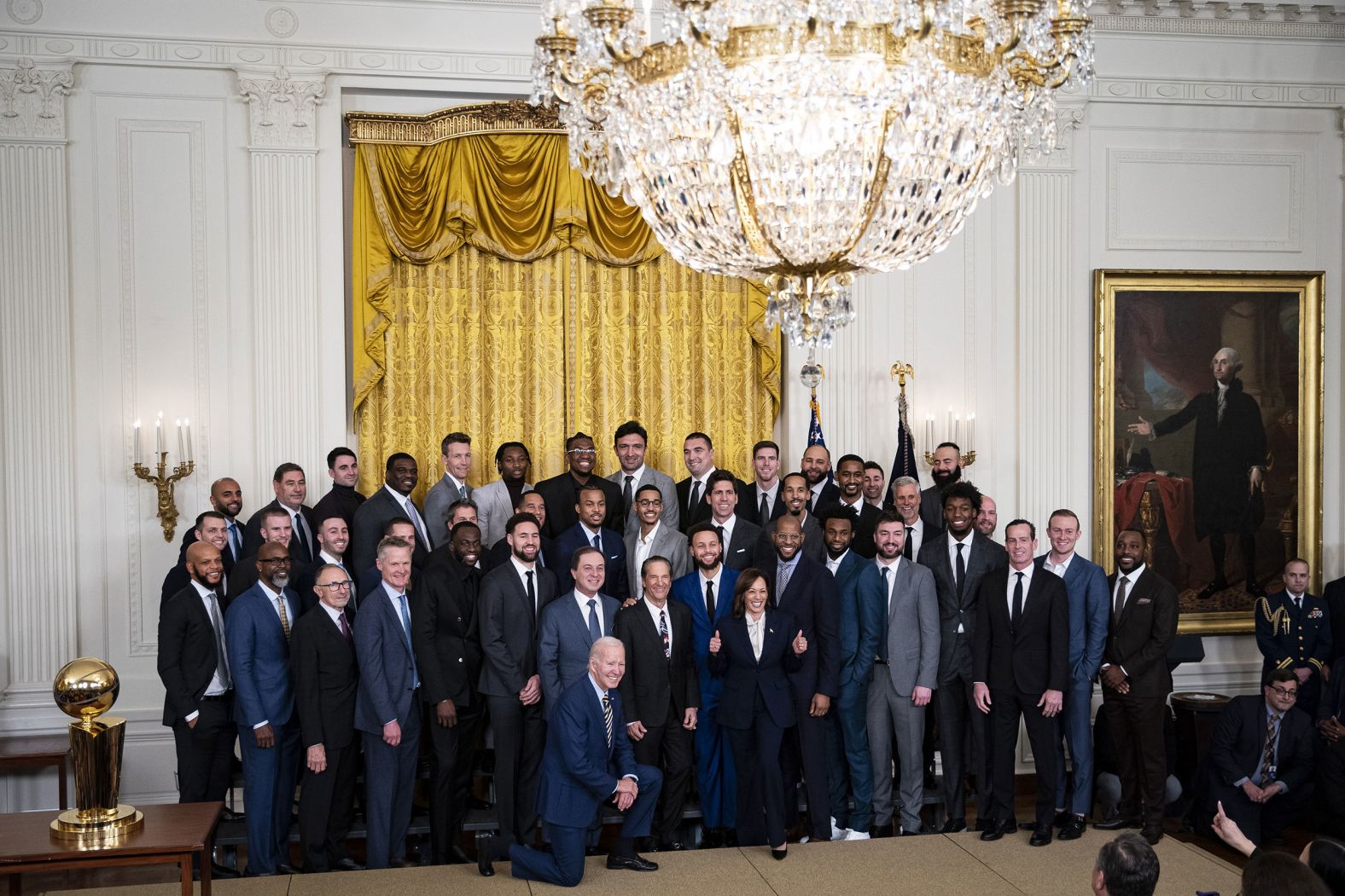 US President Joe Biden and Vice President Kamala Harris pose for a group photo with members of the Golden State Warriors basketball franchise in the East Room of the White House on Tuesday, January 17. Biden and Harris were honoring the team's 2022 NBA title.