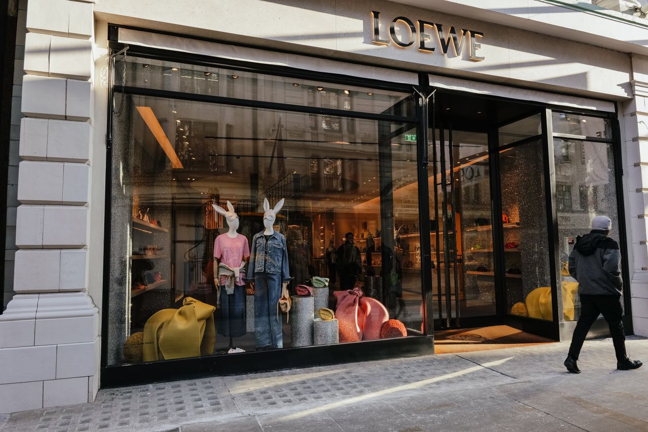 Mannequins wearing rabbit headbands in the window of the Loewe store on New Bond Street in London, UK.