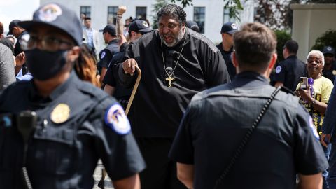 Police keep watch as The Rev. William Barber and other activists demonstrate during a rally in support of voting rights legislation in front of the US Supreme Court in Washington on June 23, 2021.