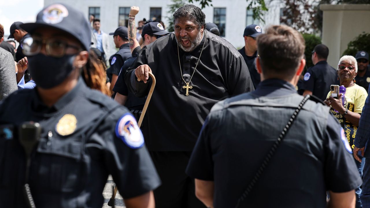 Police keep watch as The Rev. William Barber and other activists demonstrate during a rally in support of voting rights legislation in front of the US Supreme Court in Washington on June 23, 2021. 