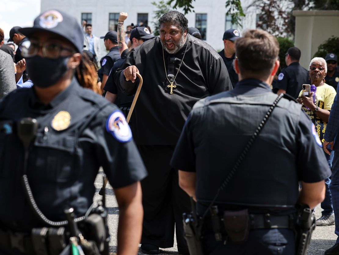 Police keep watch as The Rev. William Barber and other activists demonstrate during a rally in support of voting rights legislation in front of the US Supreme Court in Washington on June 23, 2021. 