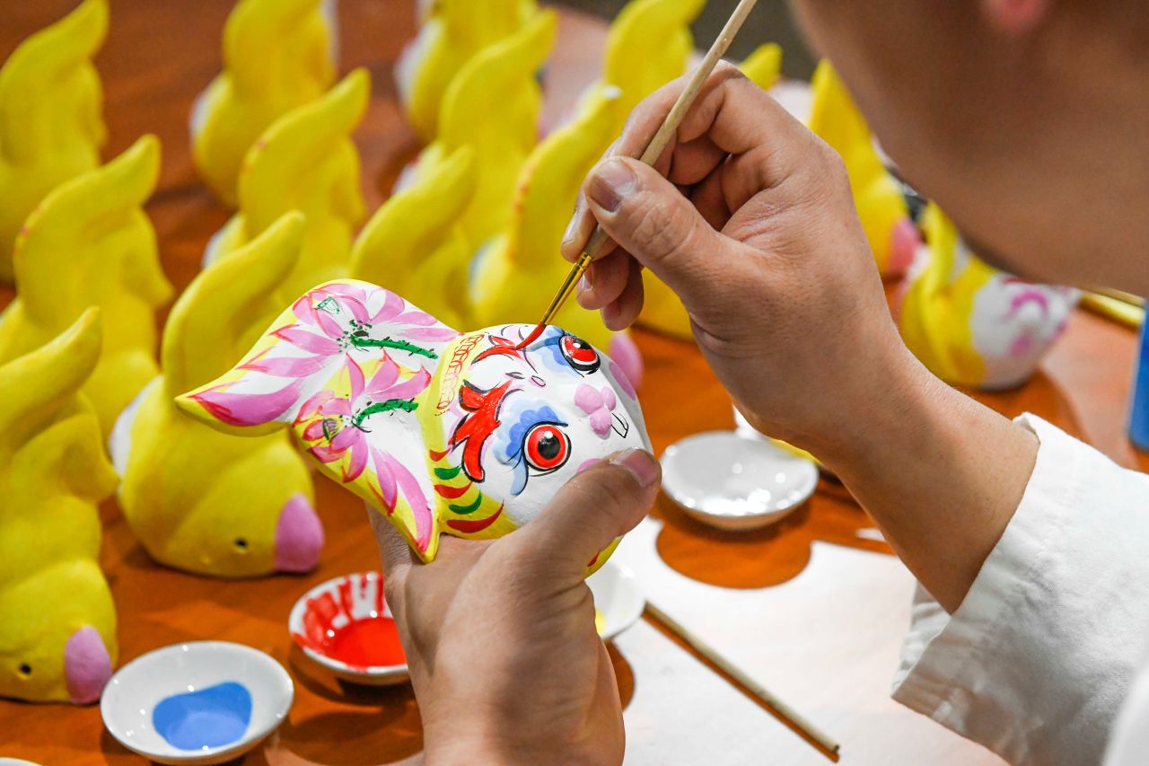 An artist colors a clay figurine at a workhop in north China's Hebei Province on January 16. As the Lunar New Year approaches, decorative items featuring rabbits, one of the 12 Chinese Zodiac animals, are sweeping the streets.
