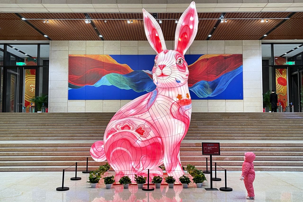 A child looks at a giant rabbit lantern at a museum in Beijing on Saturday, January 14.