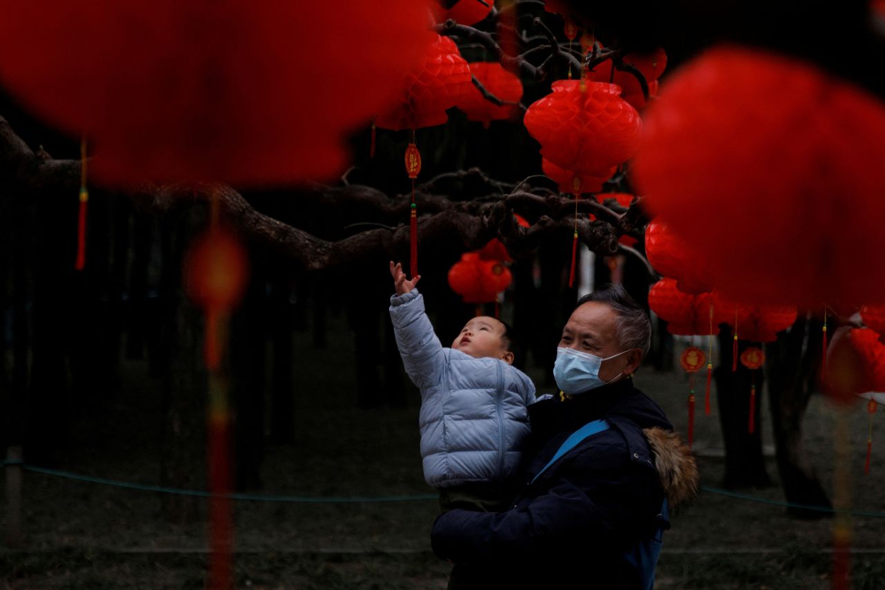 A child reaches for ornaments in a park ahead of Lunar New Year festivities in Beijing on Wednesday, January 11.