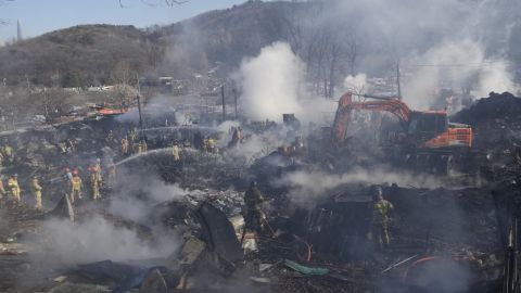 Firefighters and rescue workers at the site of a fire in Goryeong Village in Seoul, South Korea, on January 20.
