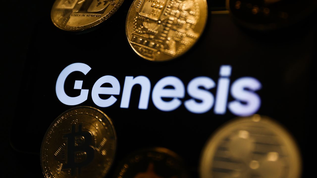 Genesis logo displayed on a phone screen and representation of cryptocurrencies are seen in this illustration photo taken in Krakow, Poland on December 1, 2022.