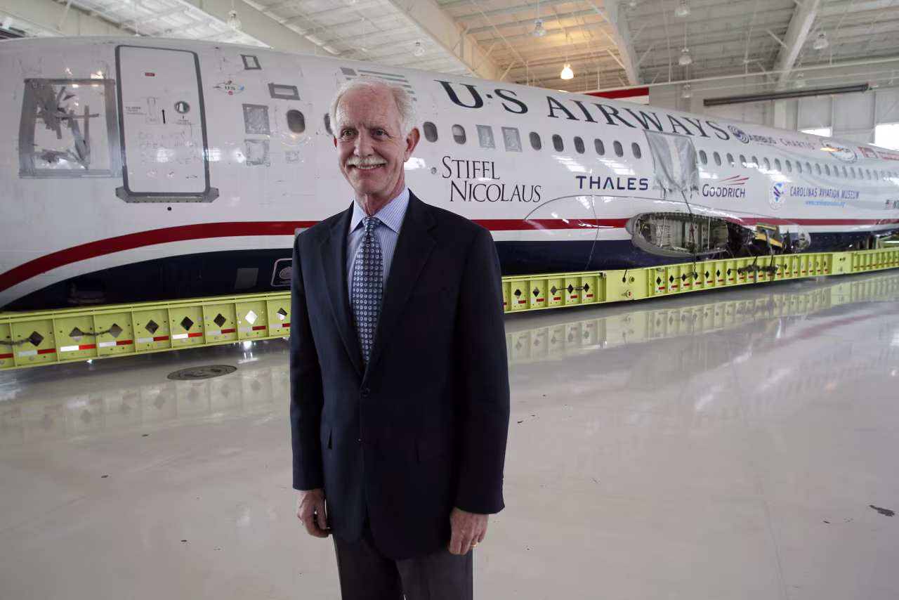 Former US Airways Captain Chesley Sullenberger of U.S. Airways flight 1549 stands in front of the plane's fuselage at Carolinas Aviation Museum in Charlotte, North Carolina June 11, 2011.  Many of the crew and passengers of the US Airways flight known as the "Miracle on the Hudson" reunite in Charlotte, North Carolina on Saturday to celebrate the plane's arrival at its intended destination two-and-a-half years after it took off. The plane that made a miraculous landing on the Hudson River two years ago in New York after a bird strike, which occurred about three minutes into the flight, resulted in an immediate and complete loss of both engines. REUTERS/Jim R. Bounds (UNITED STATES - Tags: TRANSPORT)