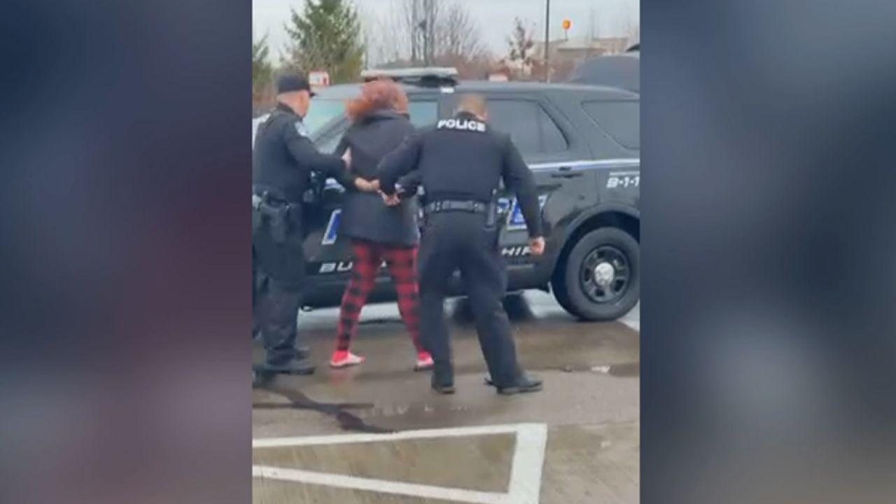 Two Ohio police officers were captured Monday on bystander video punching a woman in Ohio.