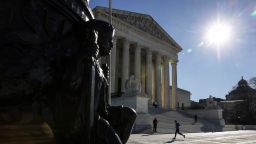 A person runs in front of the US Supreme Court in Washington, DC on December 28, 2022. 