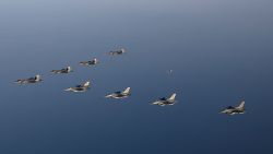 In this photo provided by South Korean Defense Ministry, four South Korean Air Force F-35 fighter jets, left top, and four US Air Force F-16 fighter jets fly over South Korea during a joint air drill in South Korea, Friday, Nov. 18, 2022. 