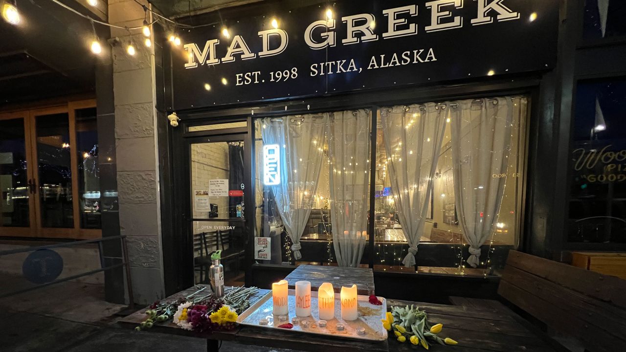 Candles and flowers are seen at a memorial for the slain University of Idaho students outside the Mad Greek restaurant in Moscow, Idaho, on January 15, 2023.