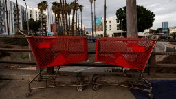 Empty shopping carts stand locked near a sidewalk homeless encampment in downtown Los Angeles, California, U.S., January 29, 2022. 