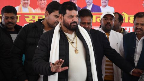 Wrestling Federation of India (WFI) President Brij Bhushan Sharan Singh (centre) arrives to speak during a press conference in Gonda on January 20, 2023.