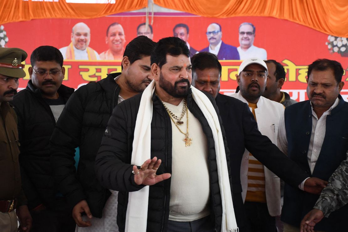 Wrestling Federation of India (WFI) president Brij Bhushan Sharan Singh (C) arrives to address a press conference in Gonda on January 20, 2023.