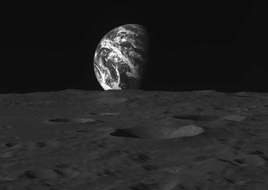 The moon's heavily cratered surface can be seen as Earth rises above it.