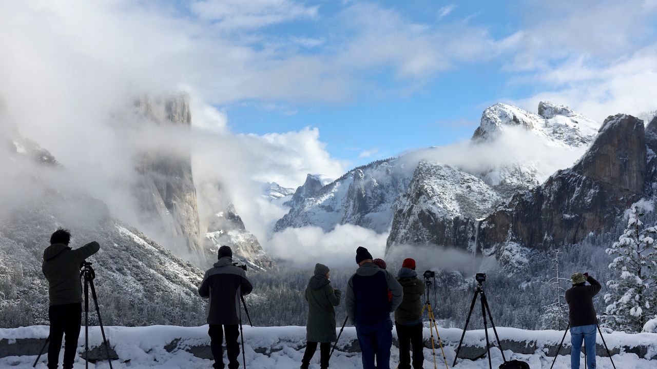 Photographers gather at a viewpoint overlooking Yosemite Valley as clouds begin to clear from the last of a series of atmospheric river storms to hit California on January 19.