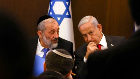 Israel's Prime Minister Benjamin Netanyahu (R) sits next to Interior and Health Minister Aryeh Deri during a weekly cabinet meeting at the prime minister's office in Jerusalem, on January 8.